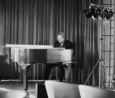 Mick Rose playing the piano at a function